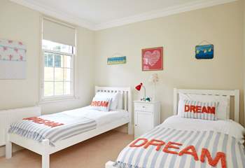 The bright twin bedroom overlooks the tennis court.