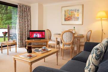 With large sliding glass doors, the sitting-room is light and comfortable.