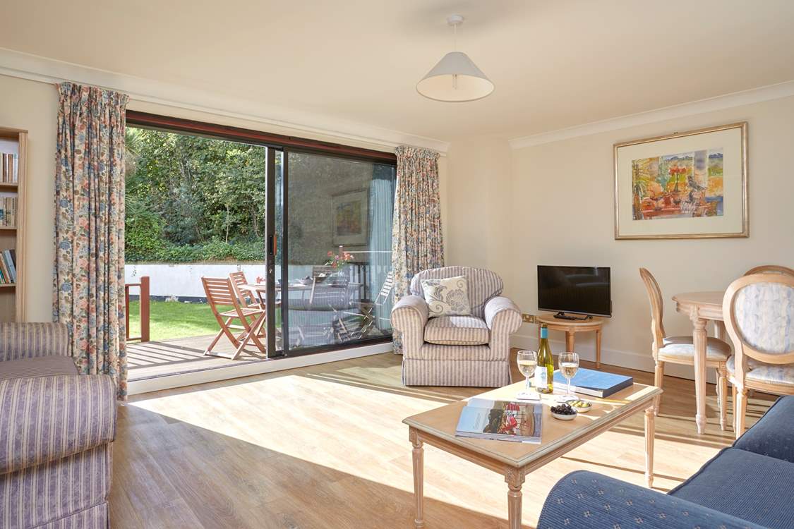 With large patio doors, the sitting-room is light and comfortable.