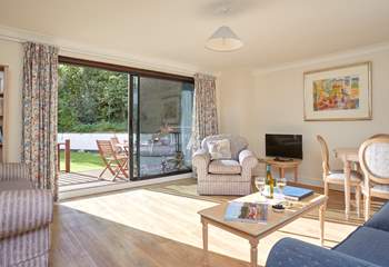 With large patio doors, the sitting-room is light and comfortable.