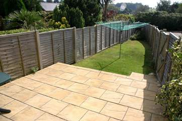 South-facing garden with patio to the rear of the property.