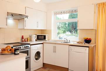 The kitchen looks out to the garden and patio at the back of the property.