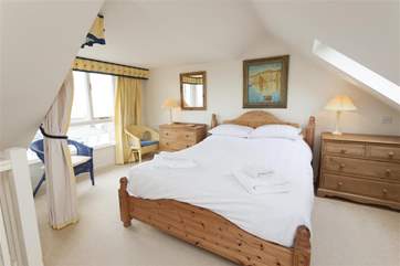 The lovely light double bedroom in the loft space on second floor.