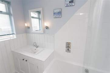 Family bathroom with shower over the bath.
