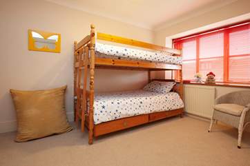 The cheerful bunk bedroom is perfect for children.