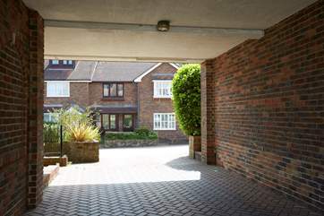 5 Sandpipers has the luxury of a private parking space through the arch.