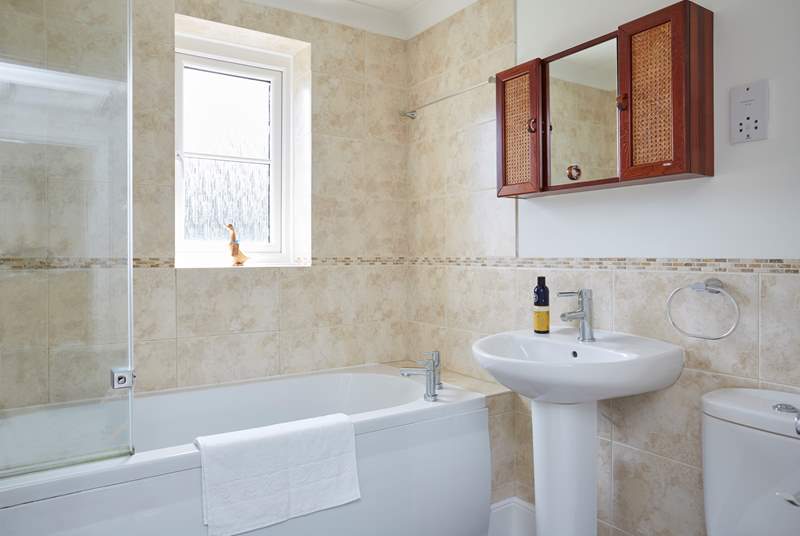 The family bathroom has a bath with a shower over it, perfect for rinsing sandy toes.