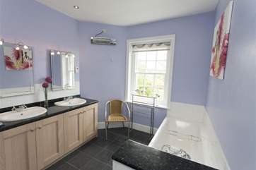 The family bathroom with bath and large walk-in shower cubicle.