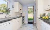 Large fully equipped kitchen with a door out to large lawned garden. - Thumbnail Image