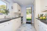 Large fully equipped kitchen with a door out to large lawned garden.