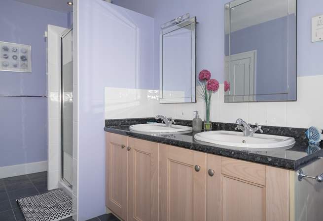 The family bathroom with bath and large walk-in shower cubicle.