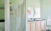 The light and airy bathroom provides a large shower cubicle and a separate bath. - Thumbnail Image