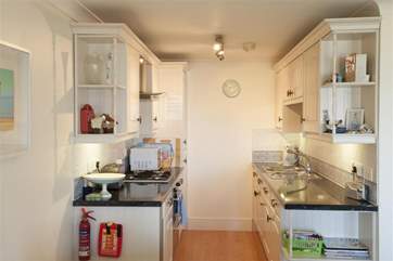Modern, fully equipped kitchen open to the dining and living area.