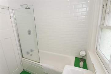 The modern family bathroom with shower over the bath.