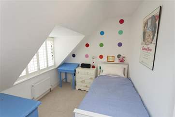 The single bedroom in the eaves on the second floor is equally cosy and bright.