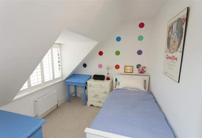 The single bedroom in the eaves on the second floor is equally cosy and bright.