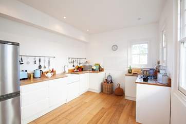 The bright modern kitchen is fully equipped.