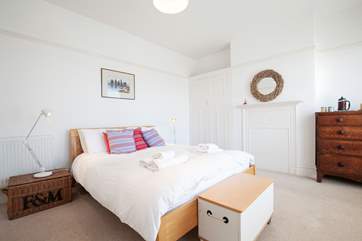 The largest of the bedrooms on the first floor features a king-sized bed.