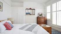 The largest of the bedrooms on the first floor features a king-sized bed.