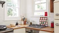 The gas hob and electric oven can be found in one corner of the kitchen. 