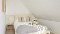 This bedroom in the eaves on the second floor is cosy and bright. Mind your head. 