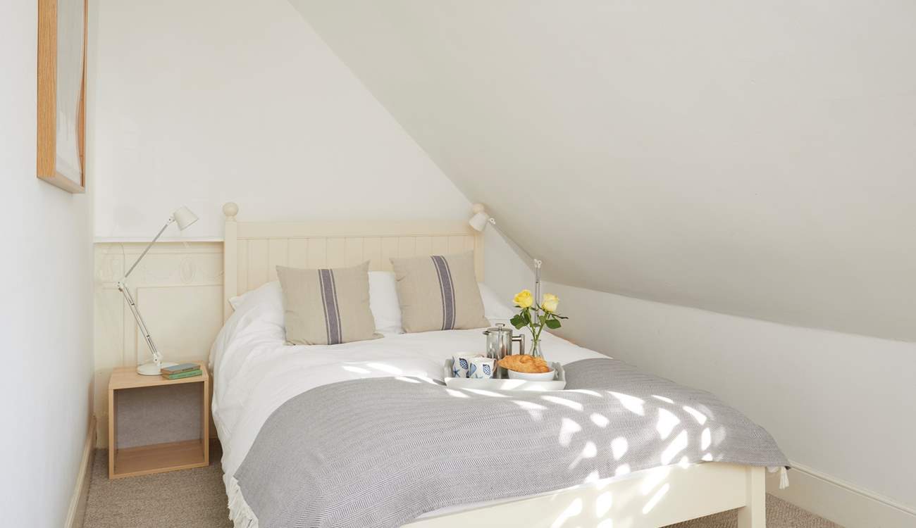 This bedroom in the eaves on the second floor is cosy and bright.