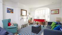 Beautiful period windows to either end of the sitting-room make this a welcoming, light and airy space.