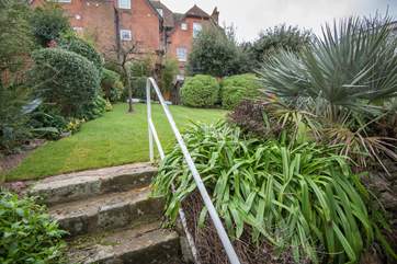 The pretty raised garden is fully enclosed with a gate at the rear that takes you onto Pier Road.