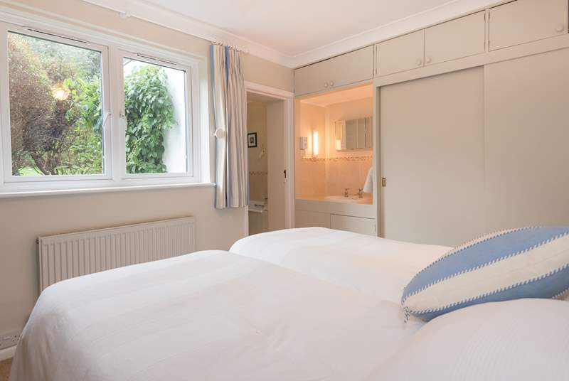 The main bedroom with wash-basin and en suite bathroom, is located to the rear of the property.