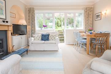 Relax in the sitting/dining-room and let the sun shine in through the door that leads into the garden.