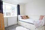 The comfortable single bedroom is cosy and full of natural light. 