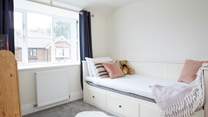 The comfortable single bedroom is cosy and full of natural light. 