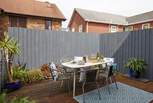 The decked terrace is fully enclosed and ready for relaxing outdoors. 