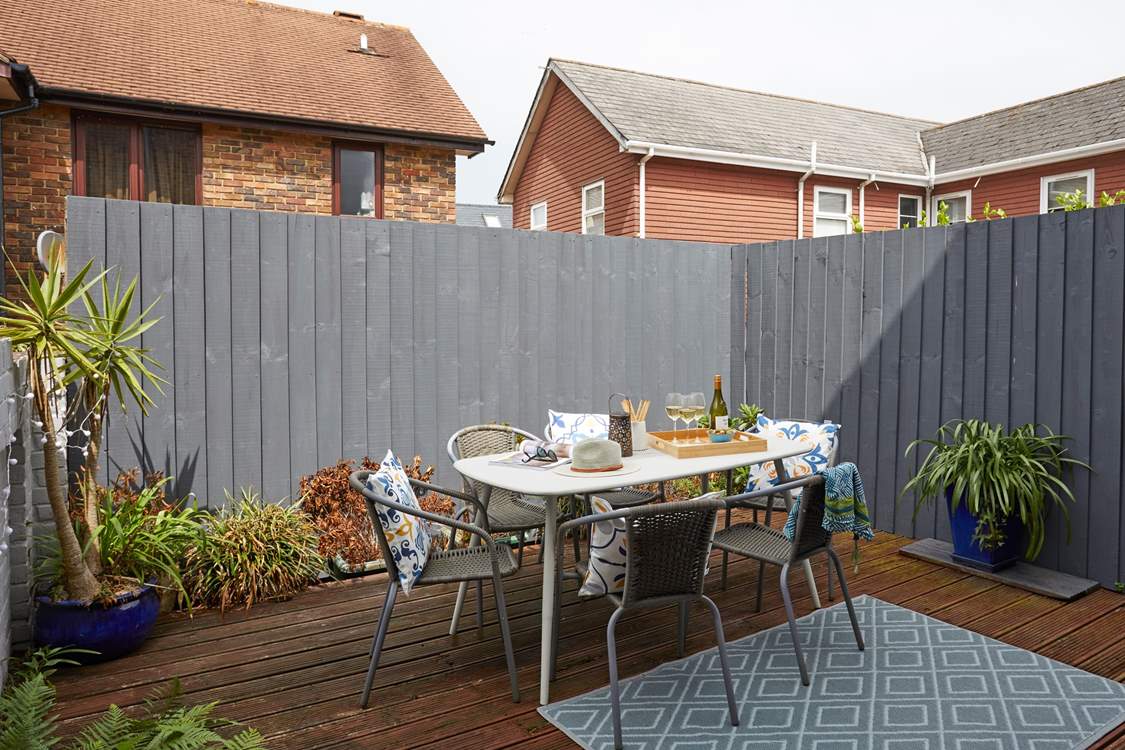 The decked terrace is fully enclosed and ready for relaxing outdoors.