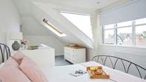 Plenty of windows allow for natural light and sea glimpses across the village rooftops. 