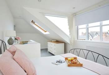 Plenty of windows allow for natural light and sea glimpses across the village rooftops. 