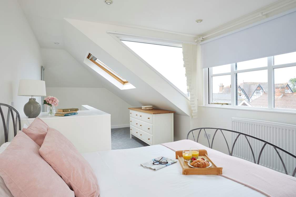 Plenty of windows allow for natural light and sea glimpses across the village rooftops.