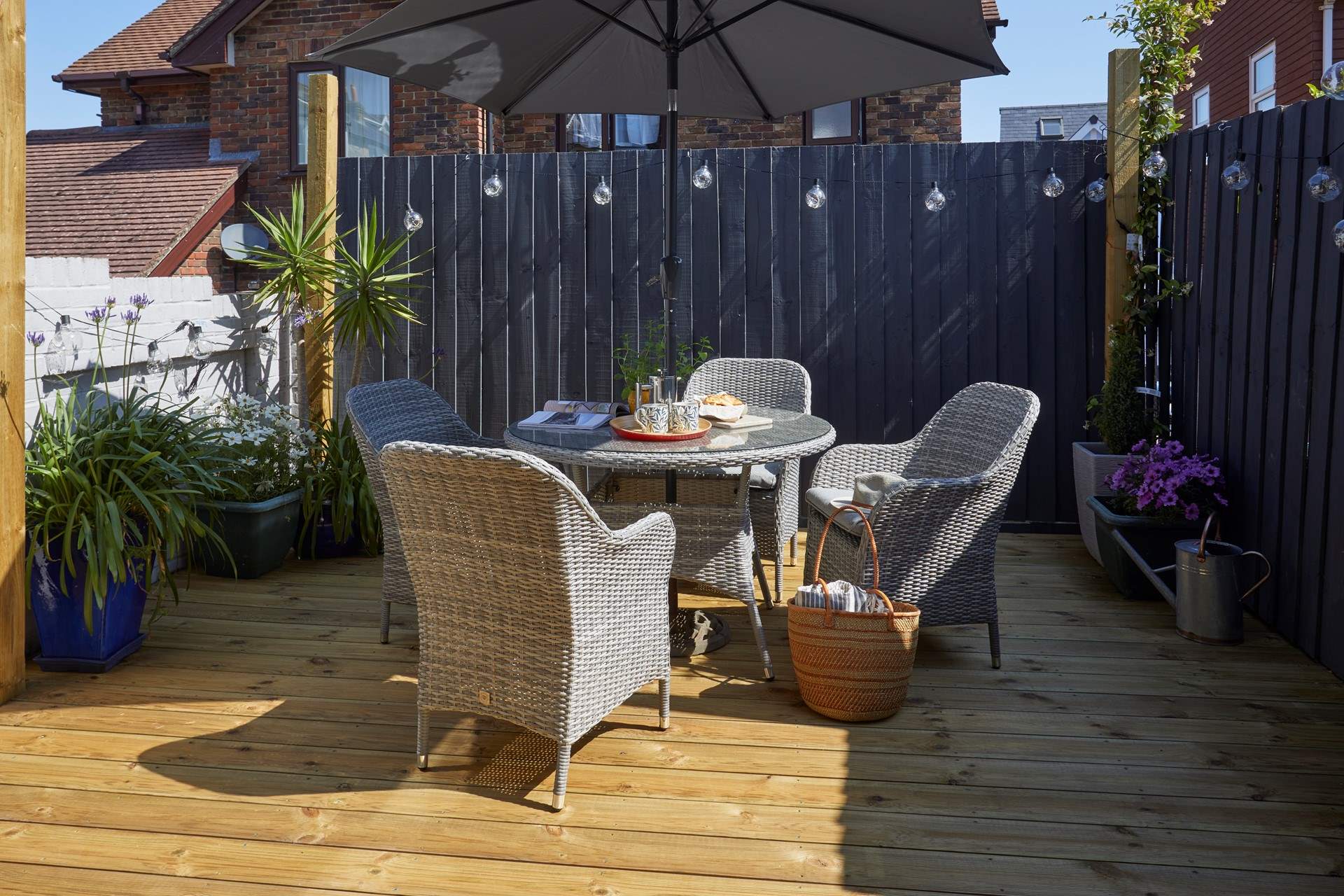 The pretty decked area complete with outdoor furniture.
