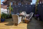 The pretty decked area complete with outdoor furniture.