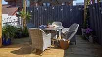 The pretty decked area complete with outdoor furniture.