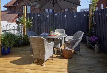 The pretty decked area complete with outdoor furniture.
