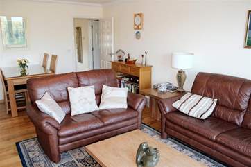 The sitting/dining-room has doors that open out to a little balcony overlooking the lake.