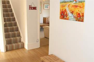 Stairs lead to the first floor where there are two bedrooms and a bathroom.