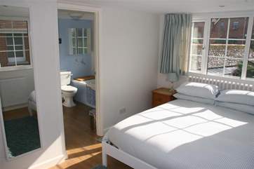 The king-size bedroom on the ground floor is spacious and bright, offering the added convenience of an en suite cloakroom.