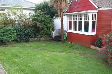 The enclosed garden to the rear of the property is a lovely private spot for enjoying the sunshine with family and friends.