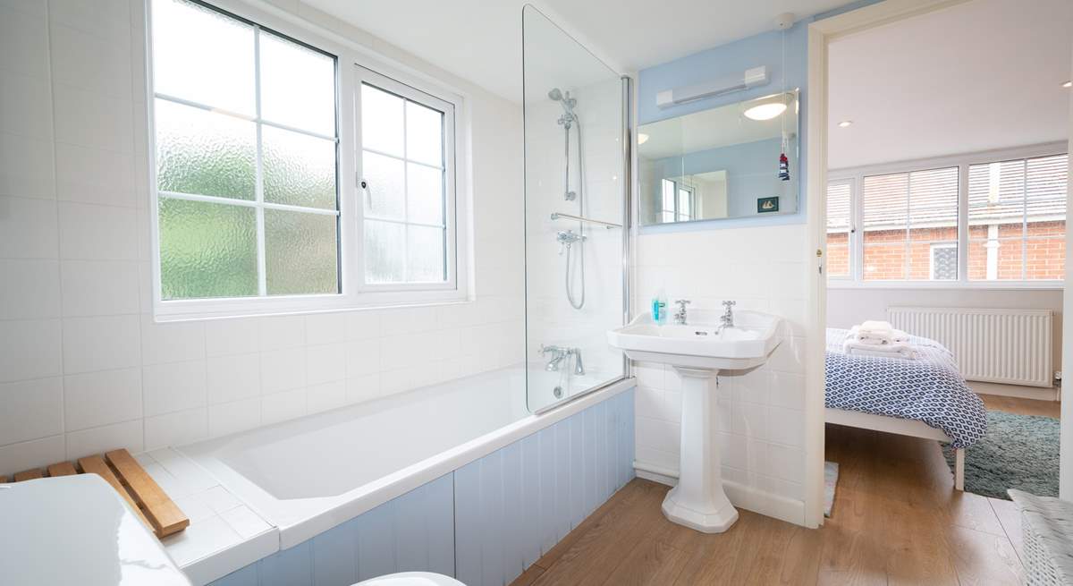 The dual access bathroom on the first floor has a shower over the bath.