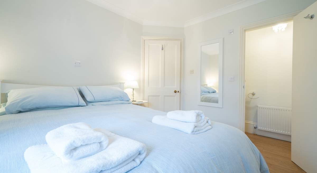 The ground floor bedroom is spacious and bright, offering the added convenience of an en suite cloakroom.