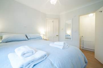 The ground floor bedroom is spacious and bright, offering the added convenience of an en suite cloakroom.
