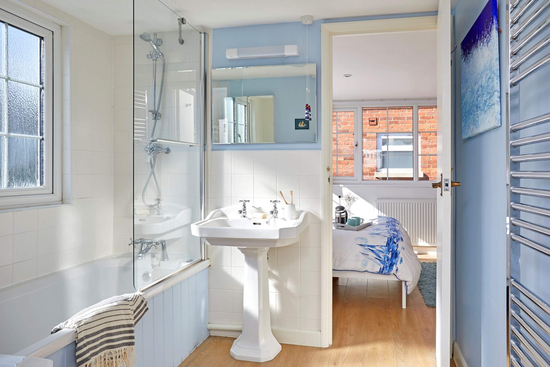 The dual-access bathroom on the first floor has a shower over the bath.