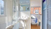 The dual-access bathroom on the first floor has a shower over the bath.
